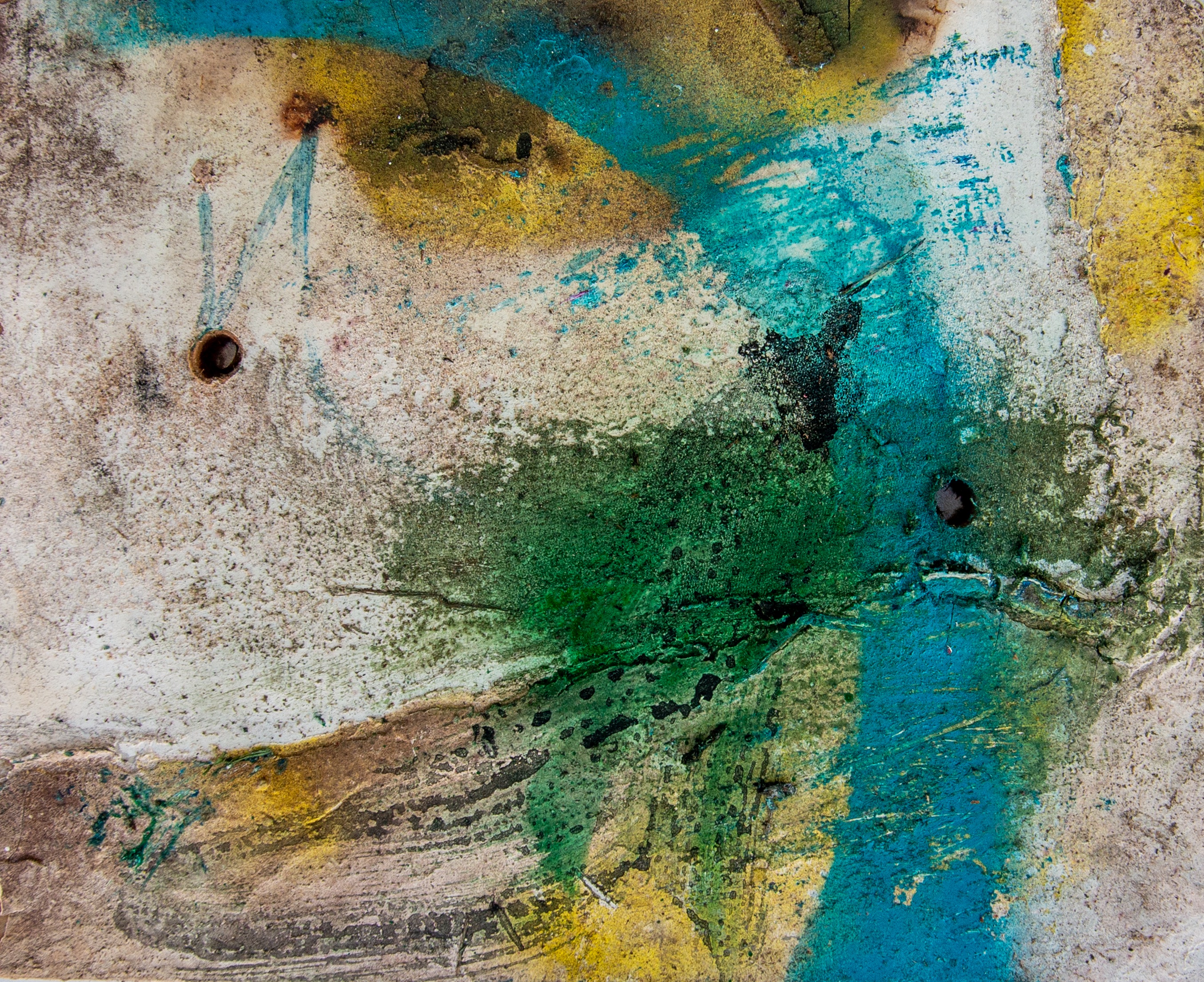 Landscape painting on a weathered chalky-white ground. Teal-blue and ochre sweeps across the upper field with a dense green splatter centred and a darker pitted patch right of centre. Two drilled holes punctuate the surface.